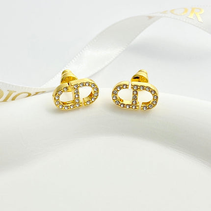 CD 26S CRYSTAL LOGO STUD EARRINGS IN GOLD METAL 633106