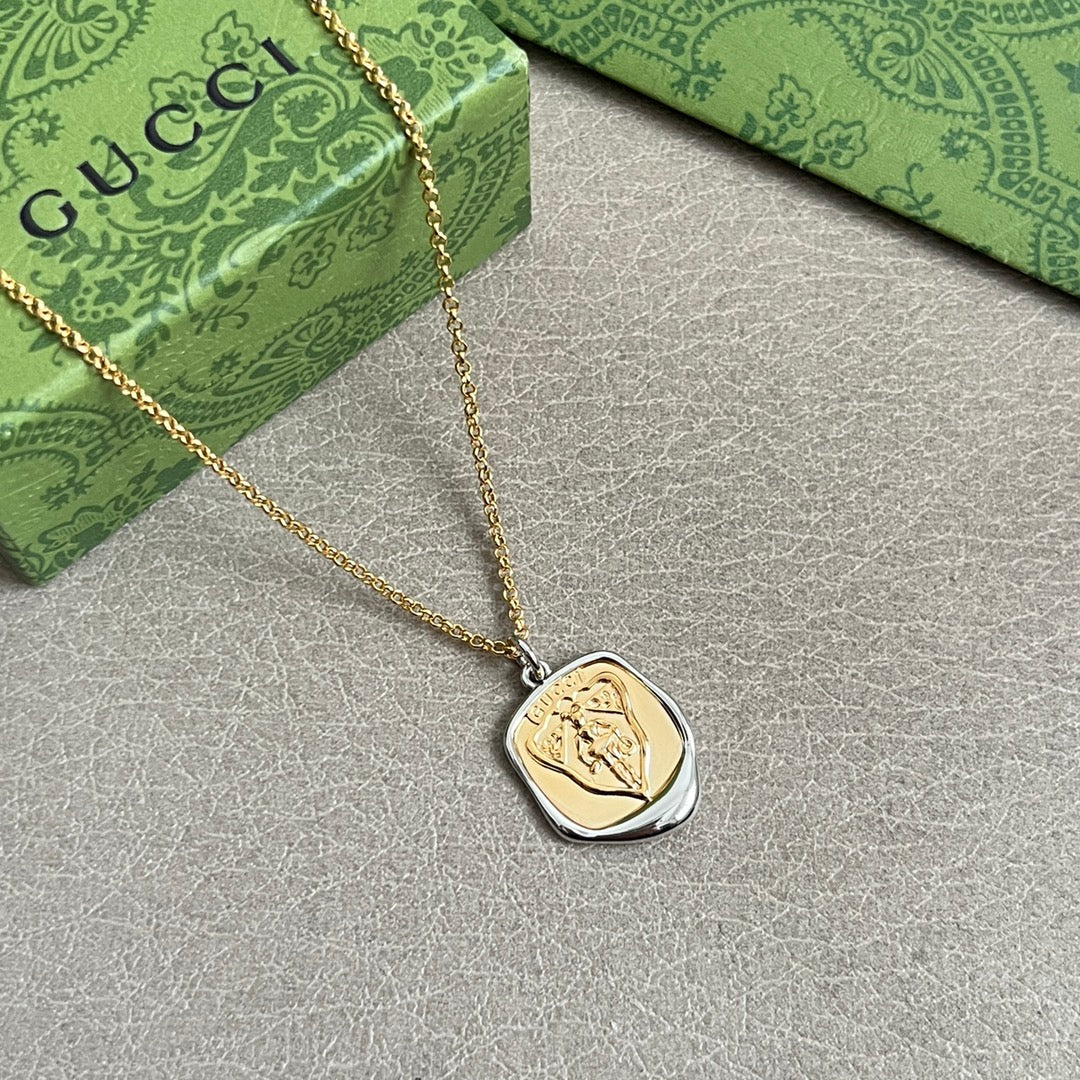 GUCCI 26S EMBLEM SHIELD PENDANT NECKLACE IN GOLD AND SILVER TONE METAL 625551
