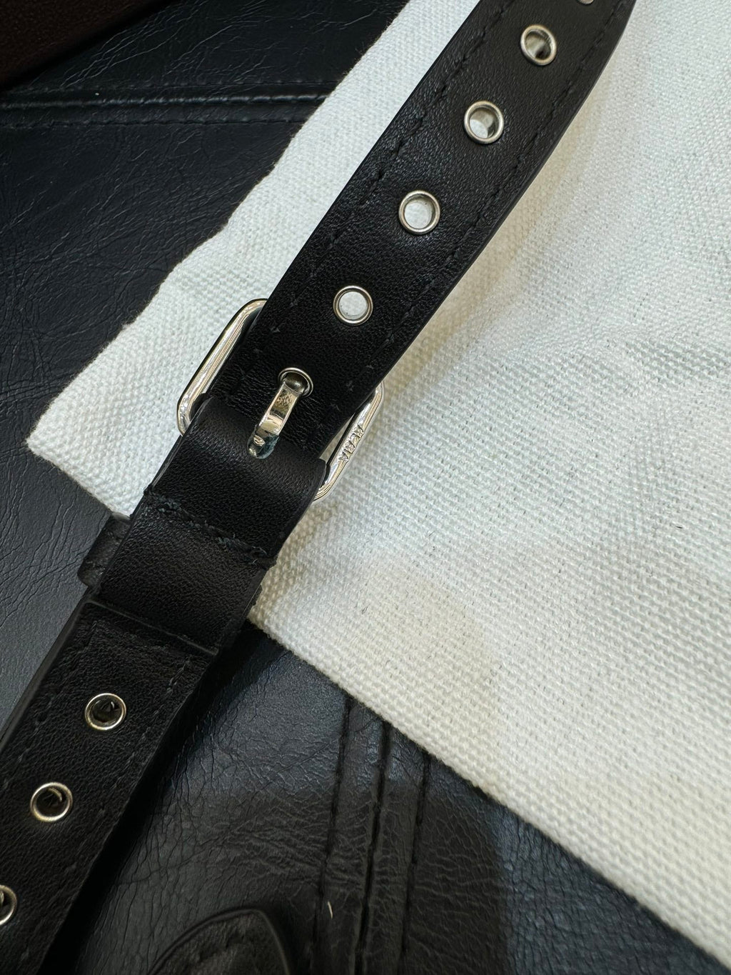 ONE PIECE DEMI LUNE BAG 31 IN BLACK SHEEPSKIN EYELET DETAILING
