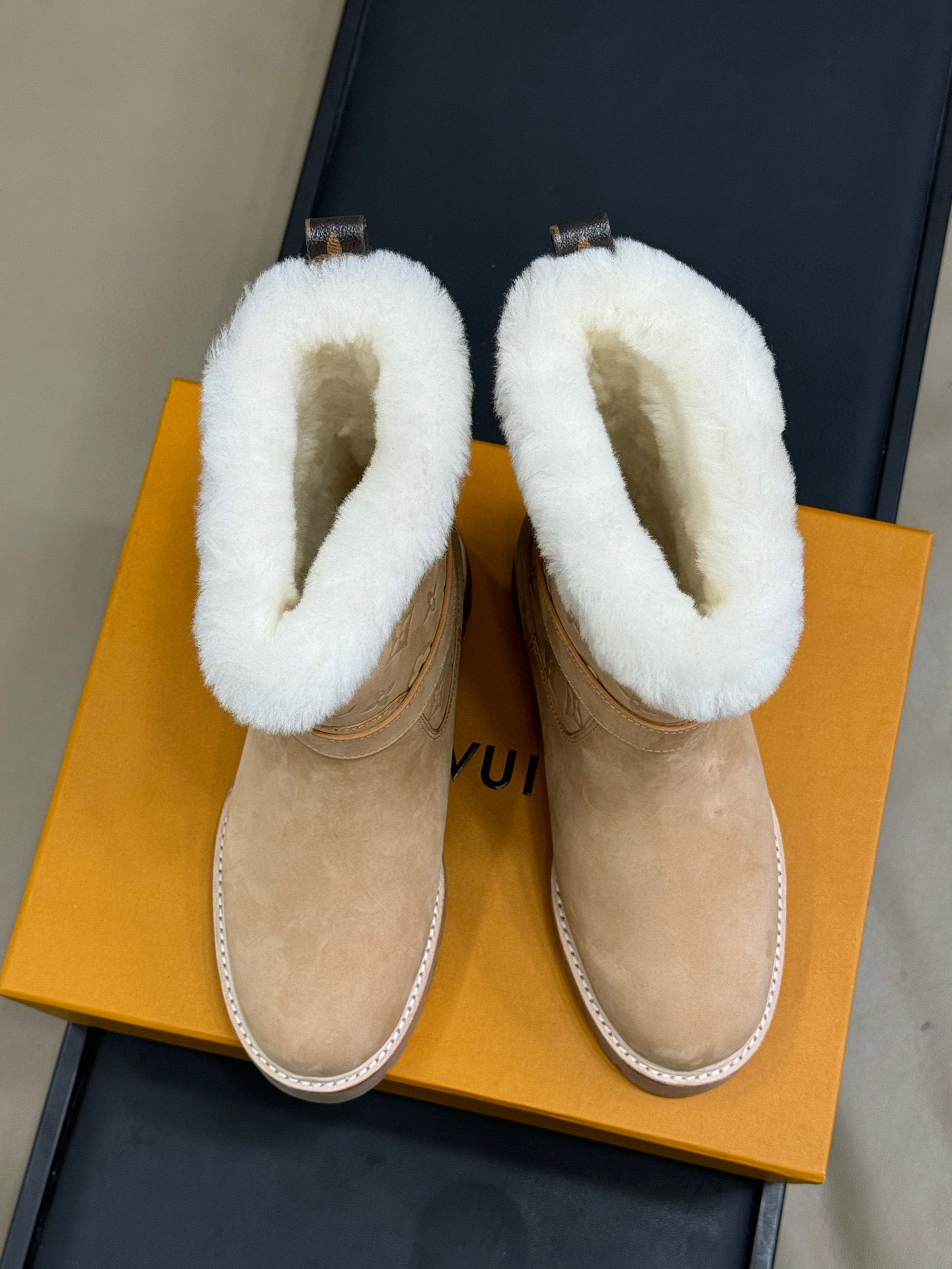 LV TERRITORY ANKLE BOOT IN BROWN AND WHITE SHEARLING LINING.