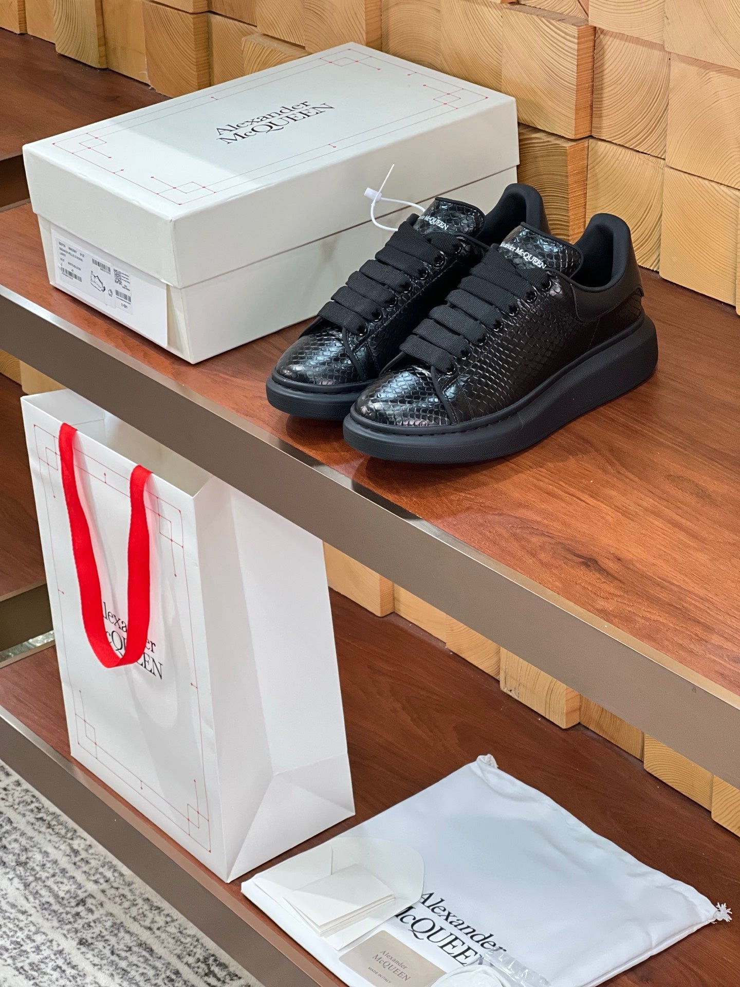 OVERSIZED SNEAKERS IN BLACK GLOSSY CALFSKIN SNAKE-EFFECT