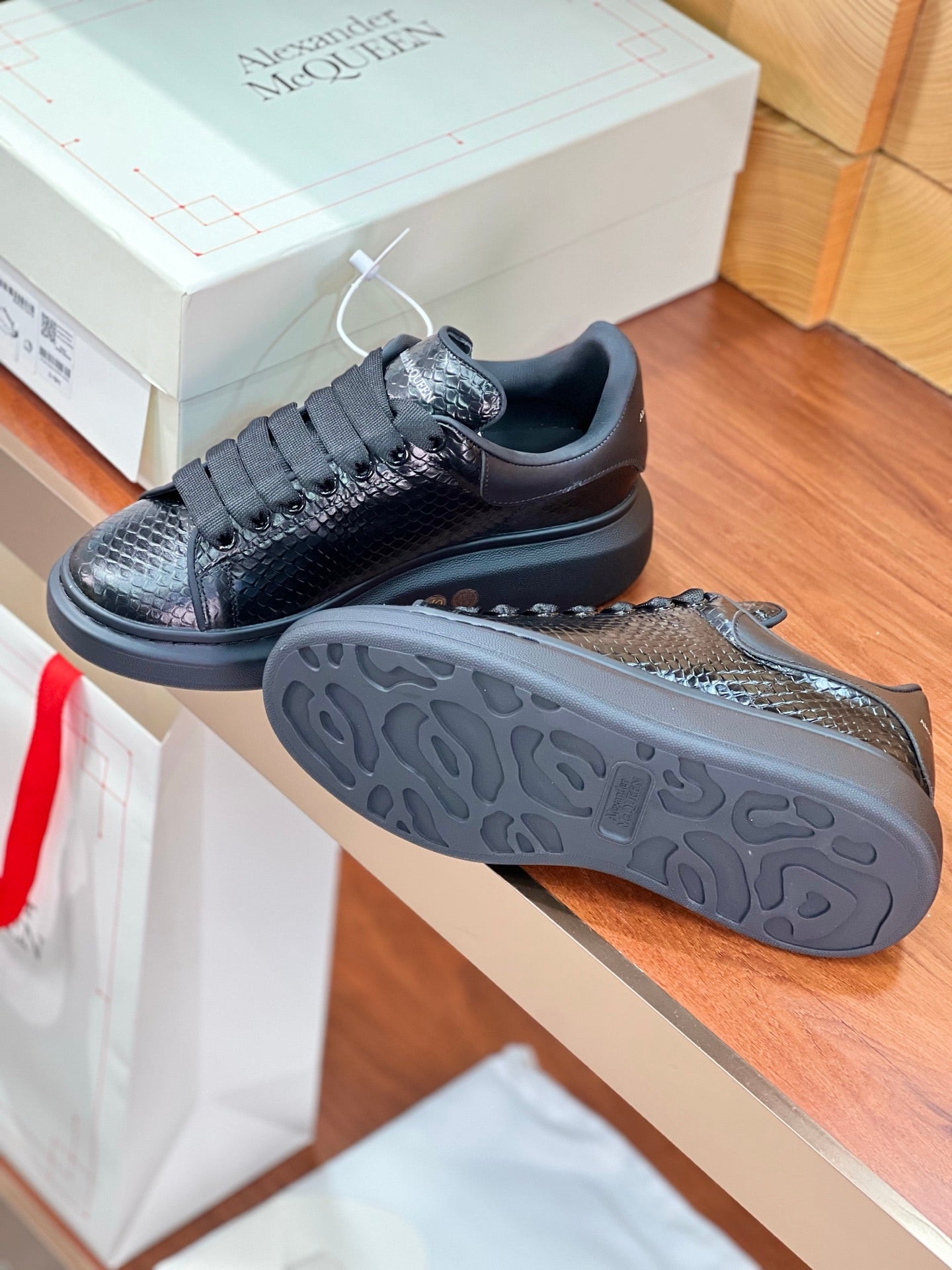 OVERSIZED SNEAKERS IN BLACK GLOSSY CALFSKIN SNAKE-EFFECT