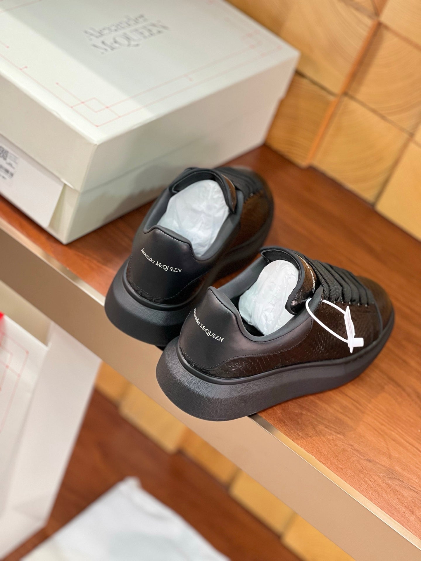 OVERSIZED SNEAKERS IN BLACK GLOSSY CALFSKIN SNAKE-EFFECT