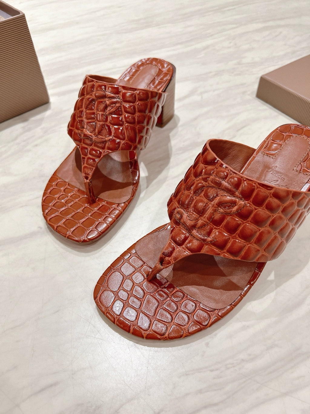EMBOIDERED LOGO MULES IN COGNAC BROWN EMBOSSED CALFSKIN