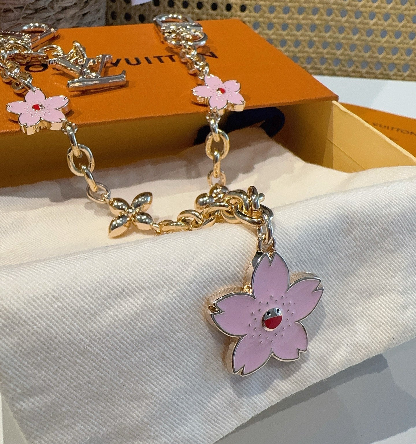 SAKURA BAG CHARM IN GOLD METAL HARDWARE