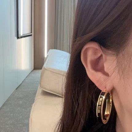 MIUMIU 26S LOGO HOOP EARRINGS IN BLACK ENAMEL AND GOLD TONE METAL 626893