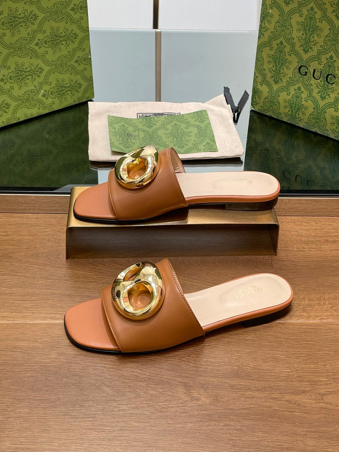 FLAT MULE IN BRONE BROWN CALFSKIN WITH GOLD HARDWARE