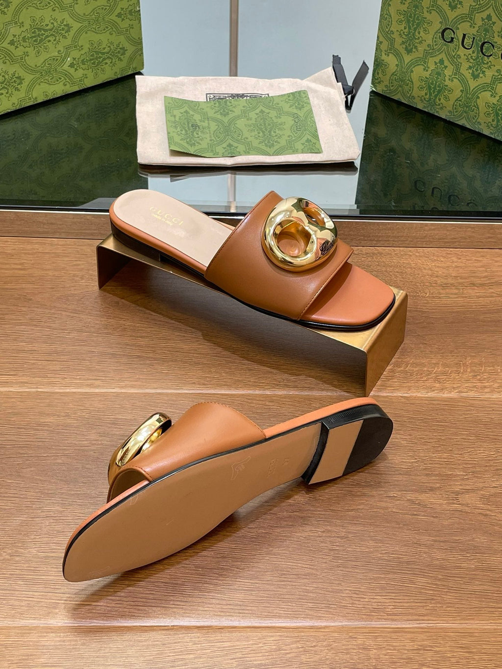 FLAT MULE IN BRONE BROWN CALFSKIN WITH GOLD HARDWARE