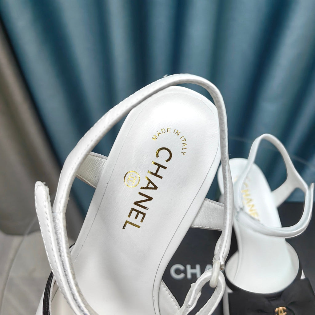 SANDALS IN WHITE SHEEPSKIN WITH BLACK SATIN BOW