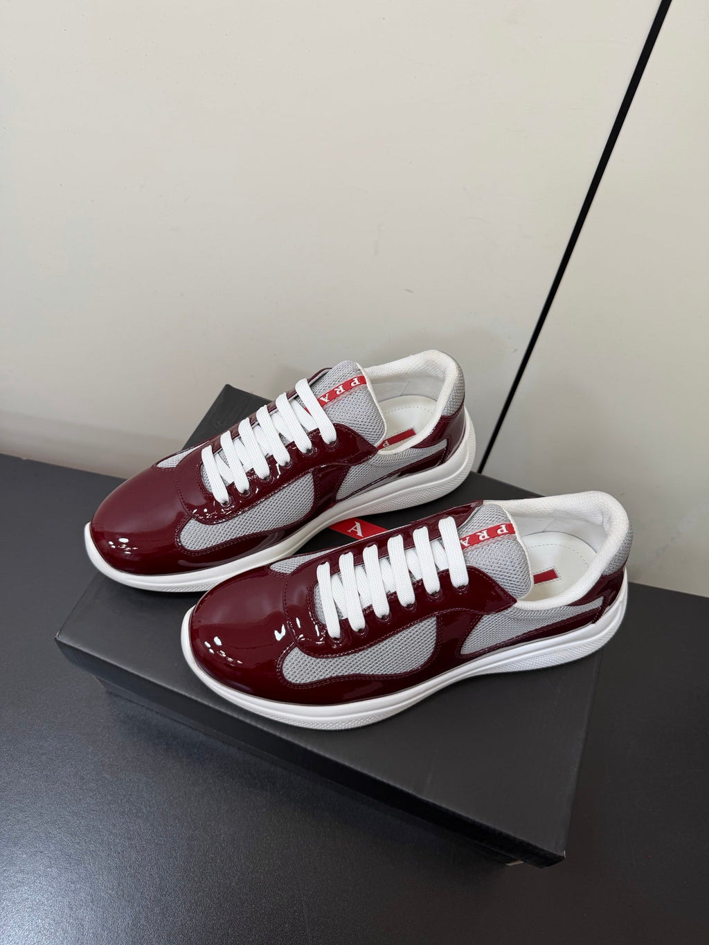 PRADA 26S SNEAKERS IN BURGUNDY RED PATENT CALFSKIN AND WHITE MESH