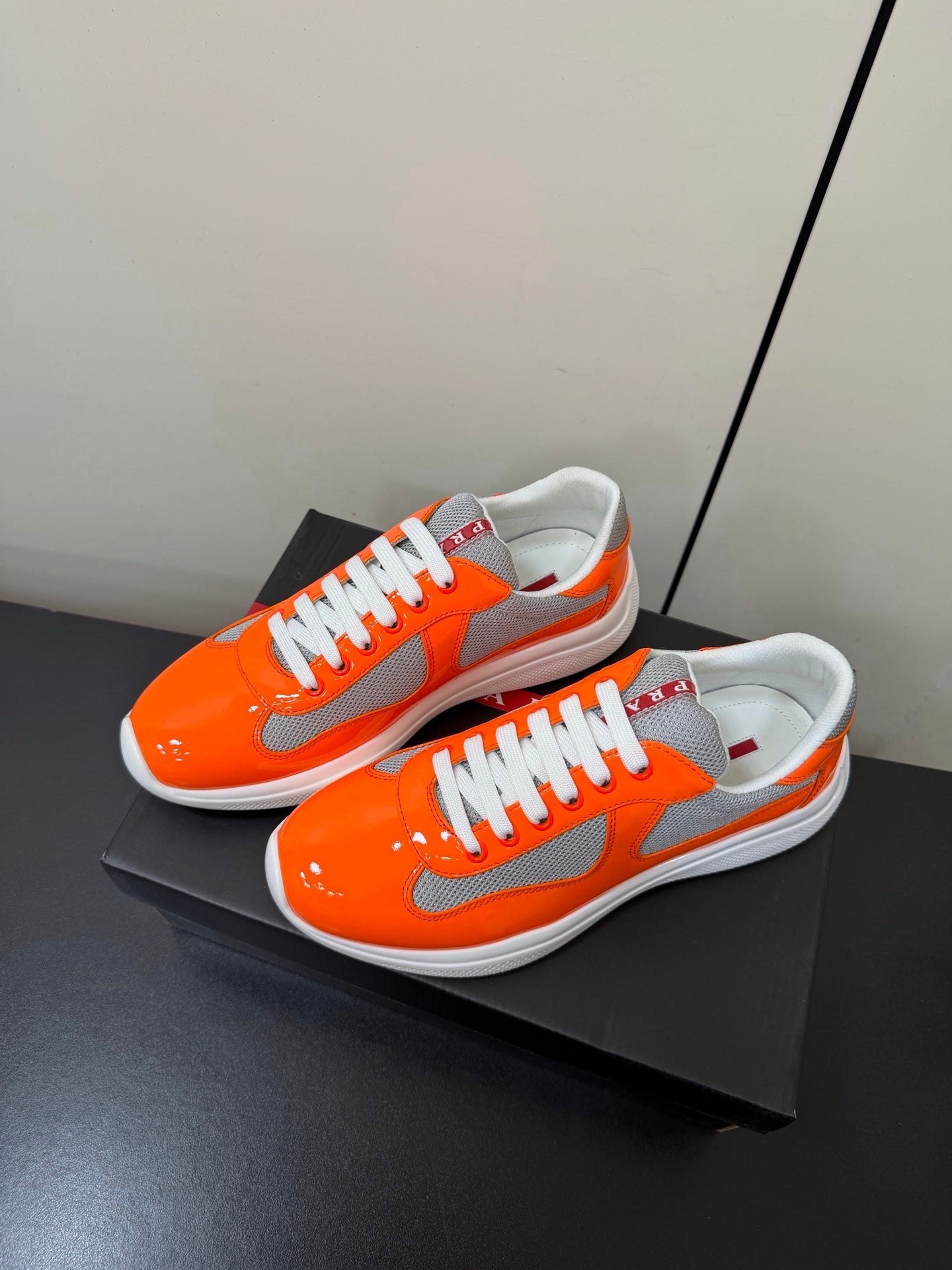 PRADA 26S SNEAKERS IN ORANGE PATENT CALFSKIN AND WHITE MESH