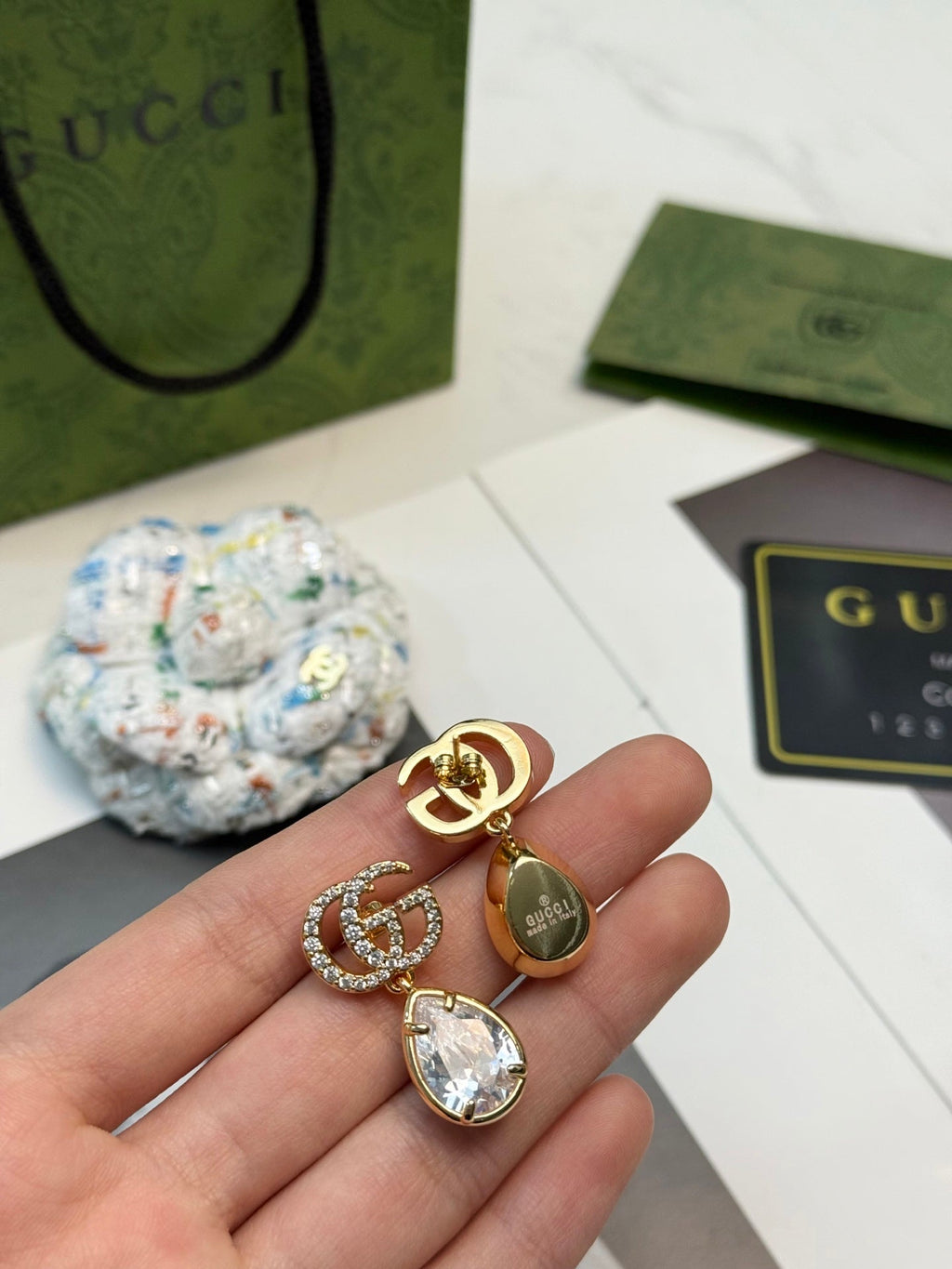GUCCI 26S INTERLOCKING GG CRYSTAL TEARDROP EARRINGS IN GOLD TONE METAL 621443