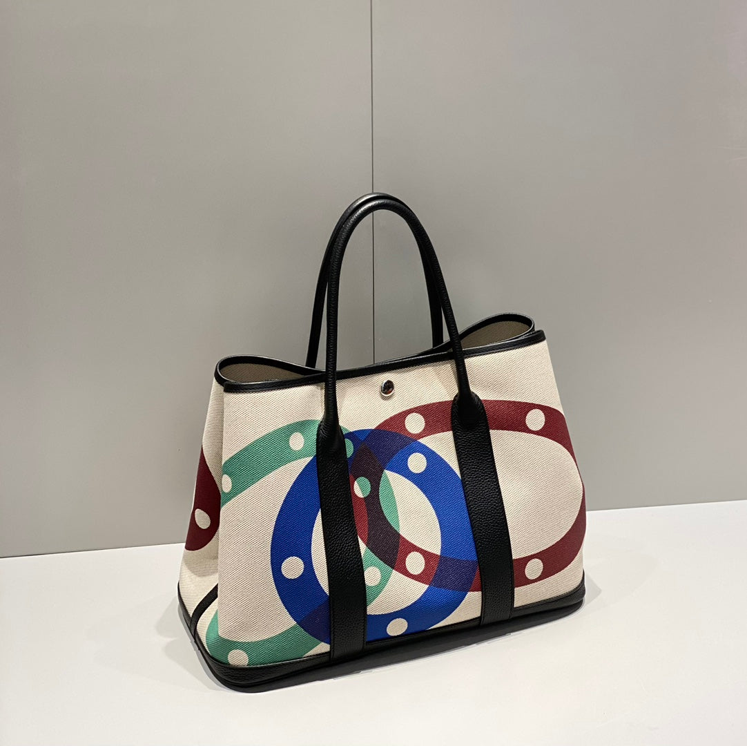 GARDEN PARTY 36 IN MULTICOLOR TOILE H CANVAS BLACK CALFSKIN OVERLAPPING POLKA RINGS PRINT