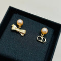 CD 26S PEARL BOW MISMATCH DROP EARRINGS IN GOLD TONE METAL 646611