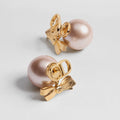 CD 26S PEARL BOW DROP EARRINGS IN GOLD TONE METAL 644484