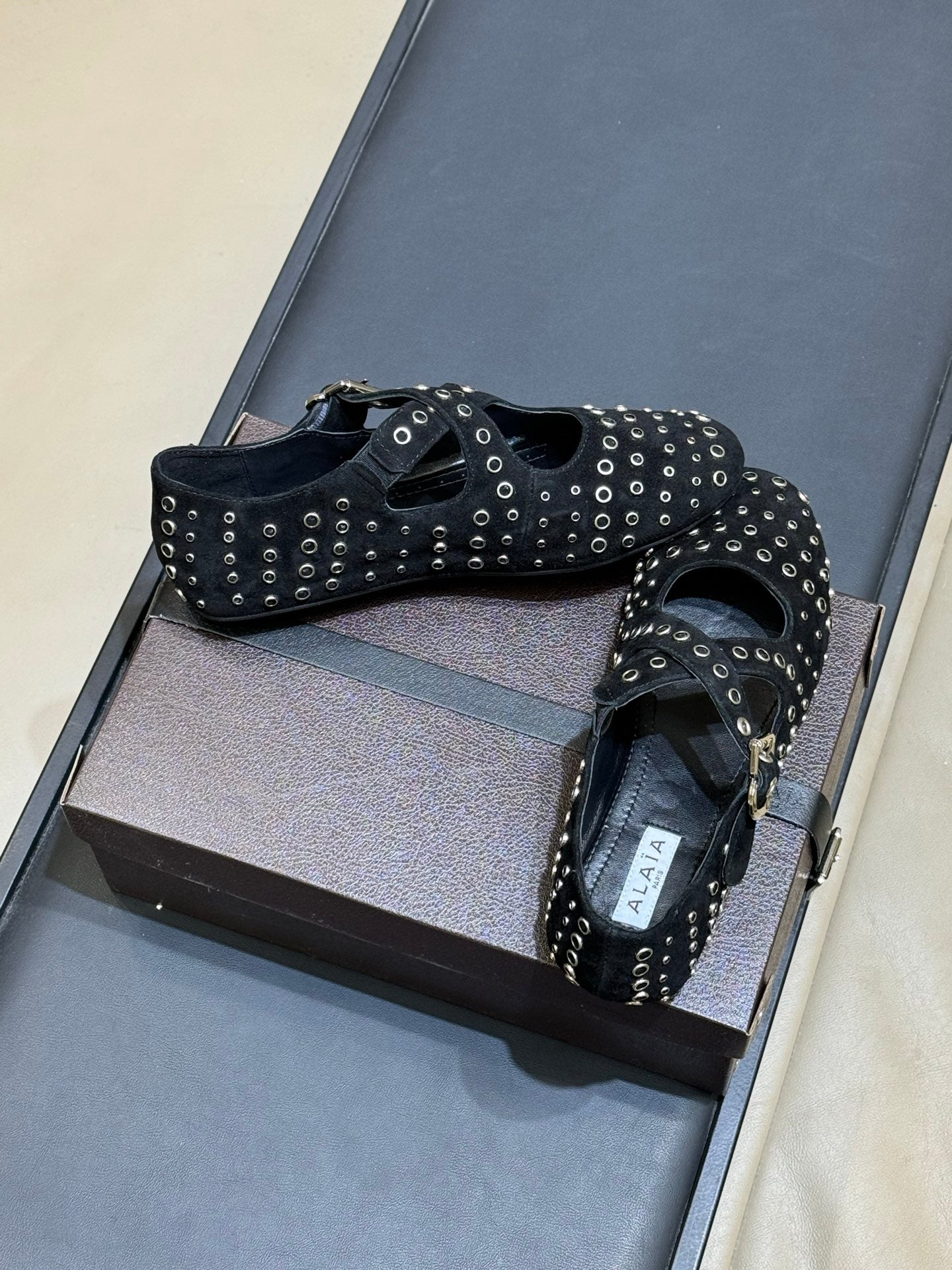 ALAIA 26S CROSS-STRAP FLATS IN BLACK SUEDE WITH SILVER HARDWARE