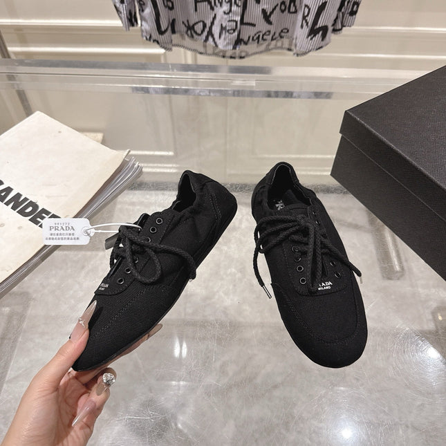 PRADA 26S COLLAPSE SNEAKERS IN BLACK CANVAS
