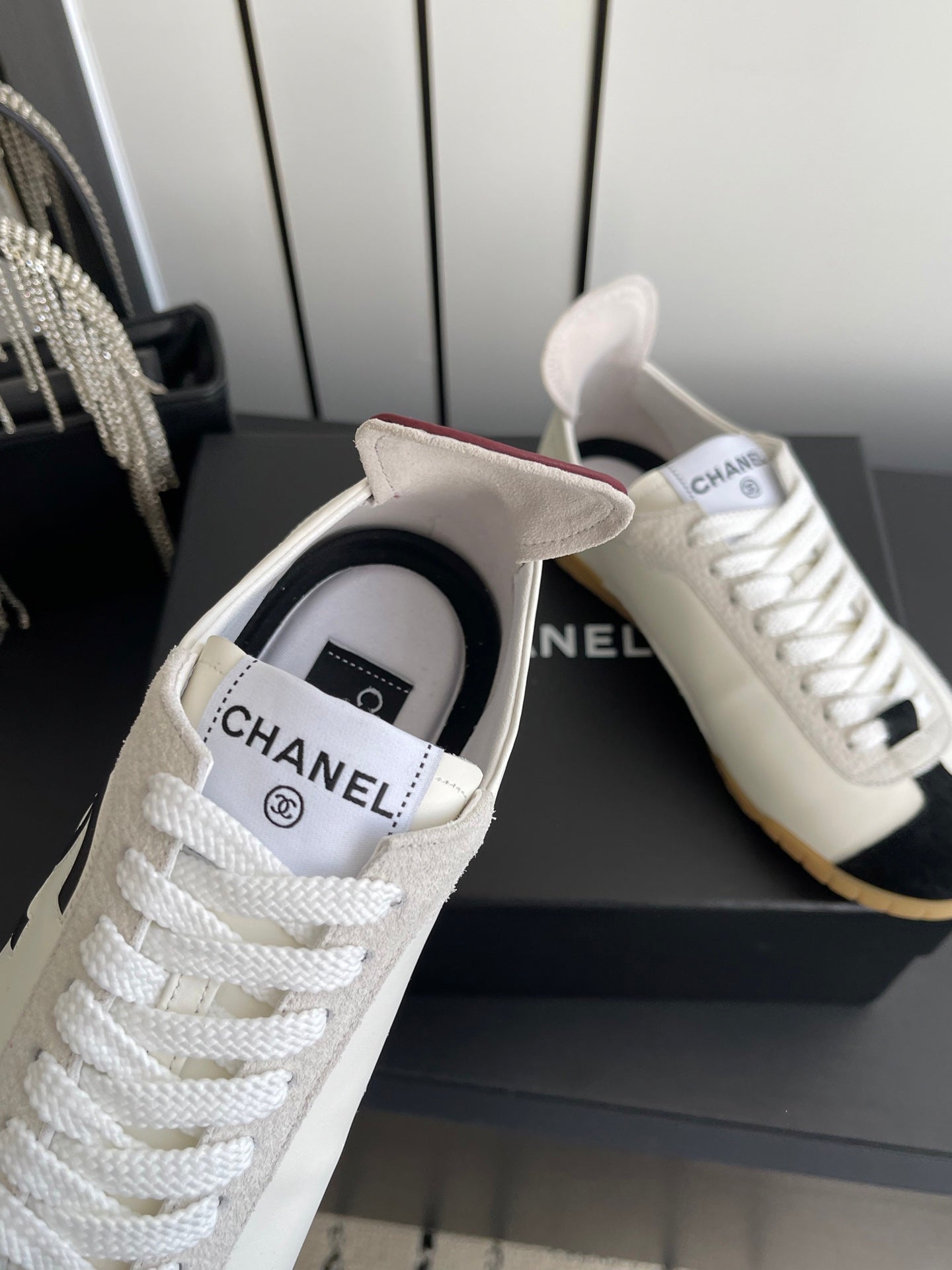 CHANEL LOW-TOP SNEAKERS IN BLACK AND WHITE CALFSKIN MIX SUEDE