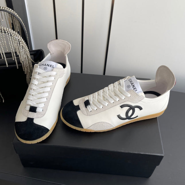 LOW-TOP SNEAKERS IN BLACK AND WHITE CALFSKIN MIX SUEDE