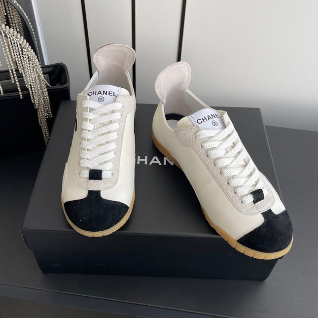 LOW-TOP SNEAKERS IN BLACK AND WHITE CALFSKIN MIX SUEDE