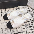 FLAT SLINGBACKS IN WHITE CALFSKIN AND BLACK FABRIC